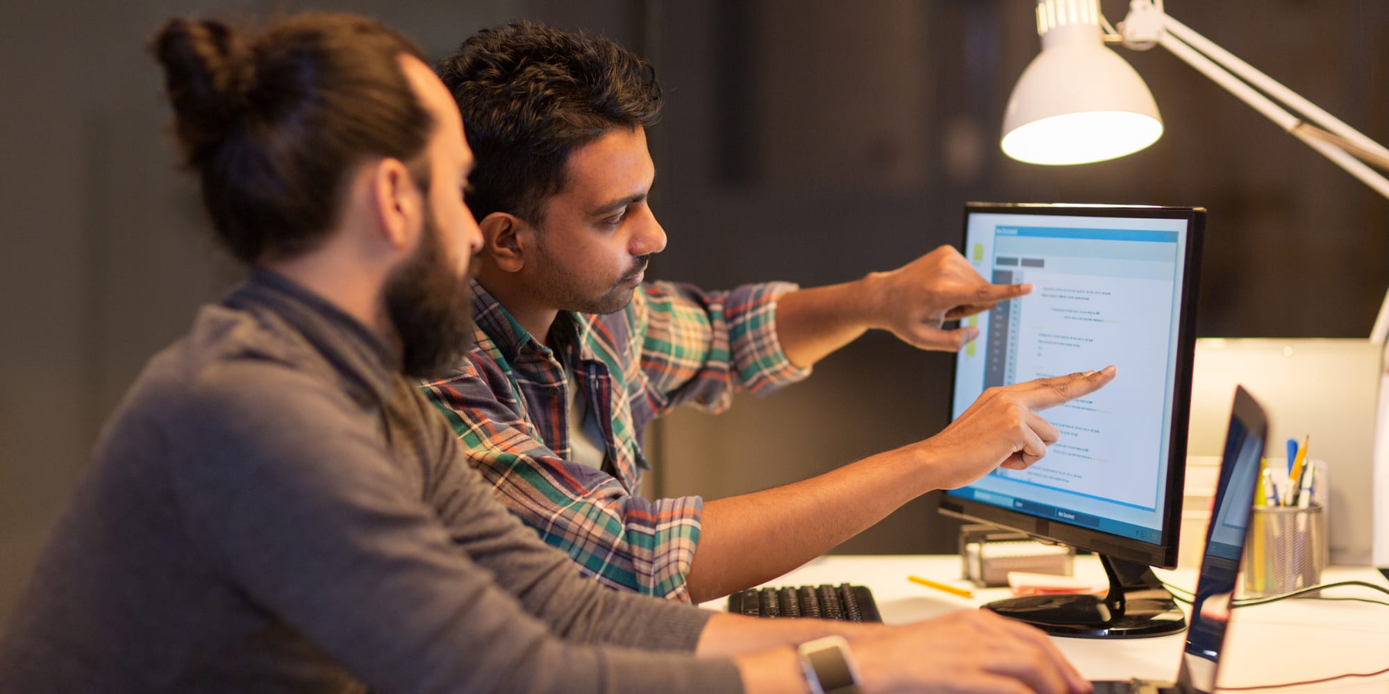 Cybersecurity graduates working on a project